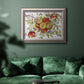 Classic still life painting of apples in an ornate vintage silver frame displayed in a dark-toned interior setting.