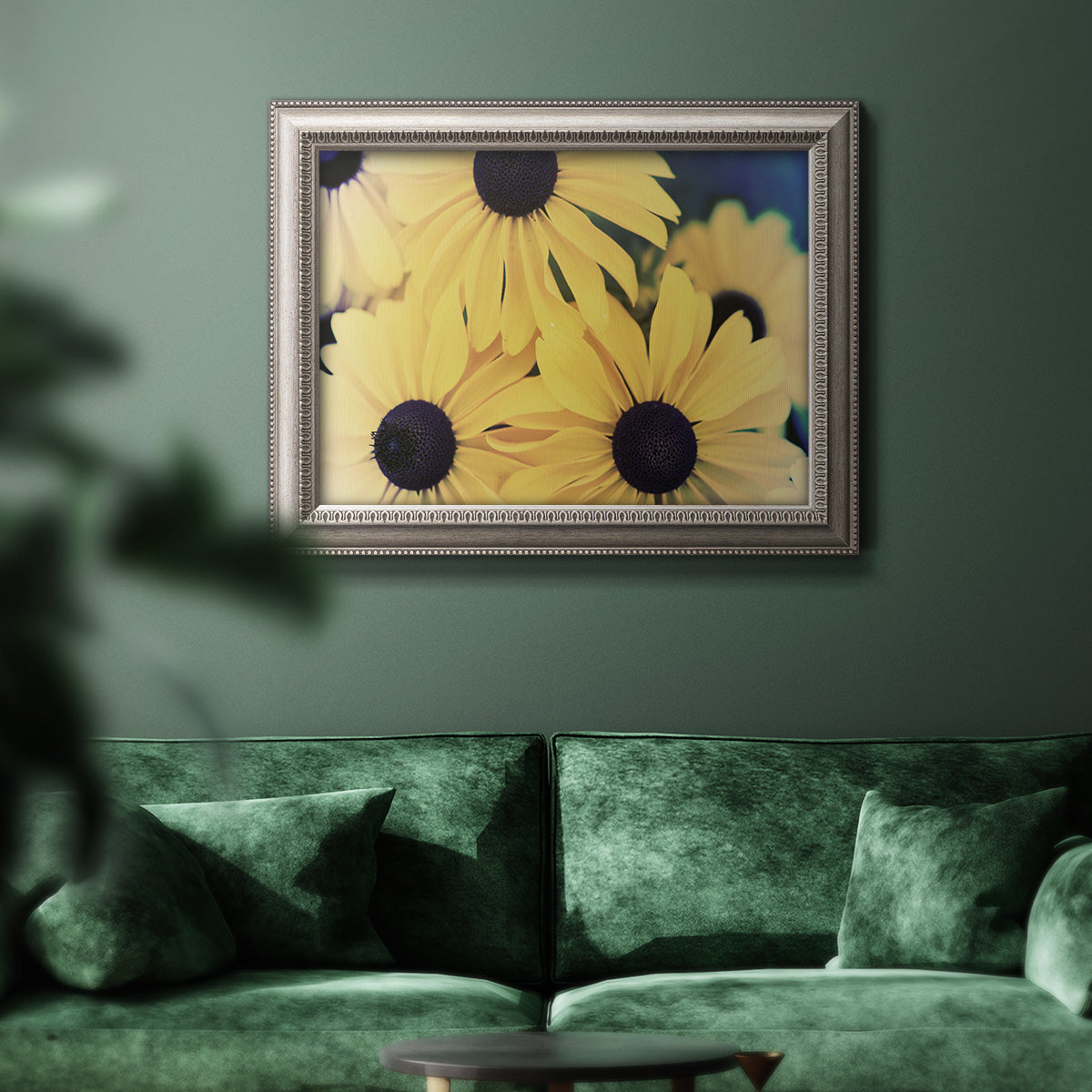 Modern sunflower-style Susan floral photograph in an ornate vintage silver frame displayed in a dark-toned interior setting.