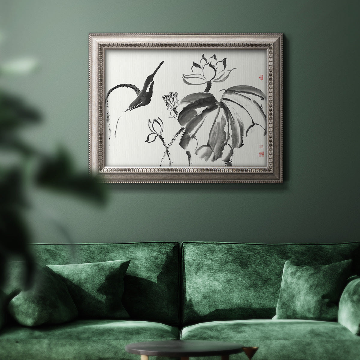 Asian-inspired lotus flower illustration in an ornate vintage silver frame displayed in a dark-toned interior setting.