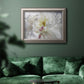 White floral photography close-up in an ornate vintage silver frame displayed in a dark-toned interior setting.