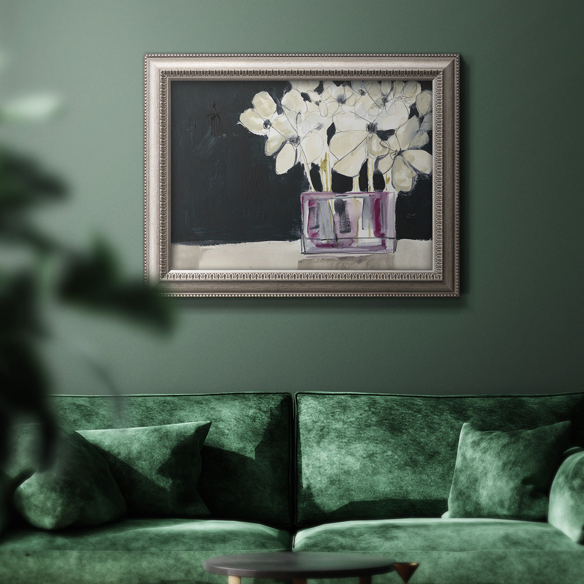 Modern abstract white floral watercolor artwork in an ornate vintage silver frame displayed in a dark-toned interior setting.
