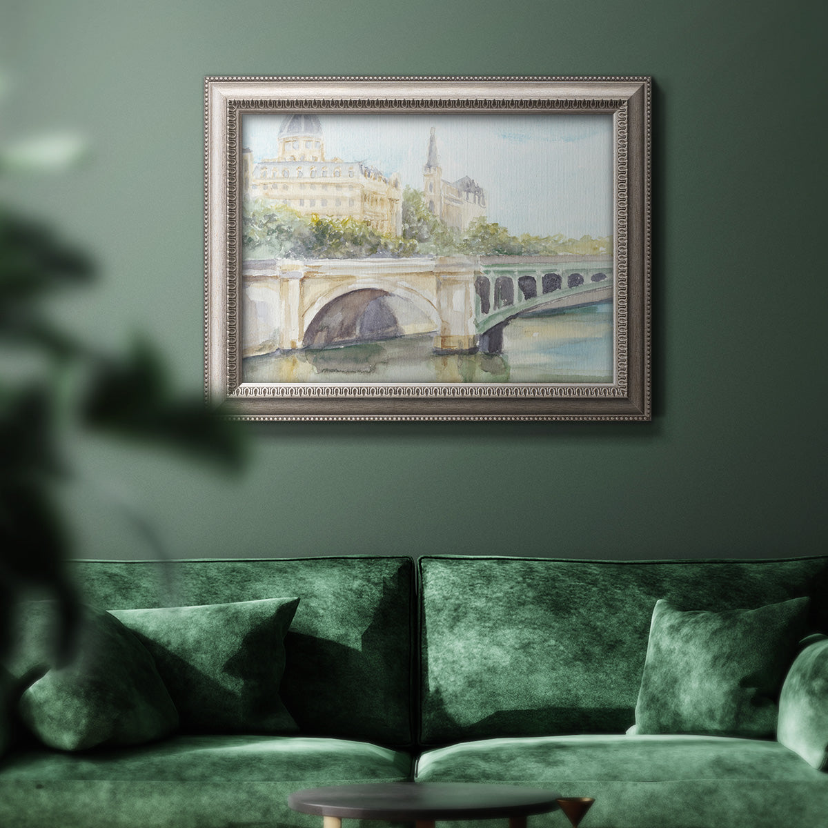Classical watercolor painting of a French bridge in an ornate vintage silver frame displayed in a dark-toned interior setting.
