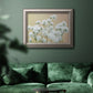 Delicate baby’s breath floral photograph in an ornate vintage silver frame displayed in a dark-toned interior setting.