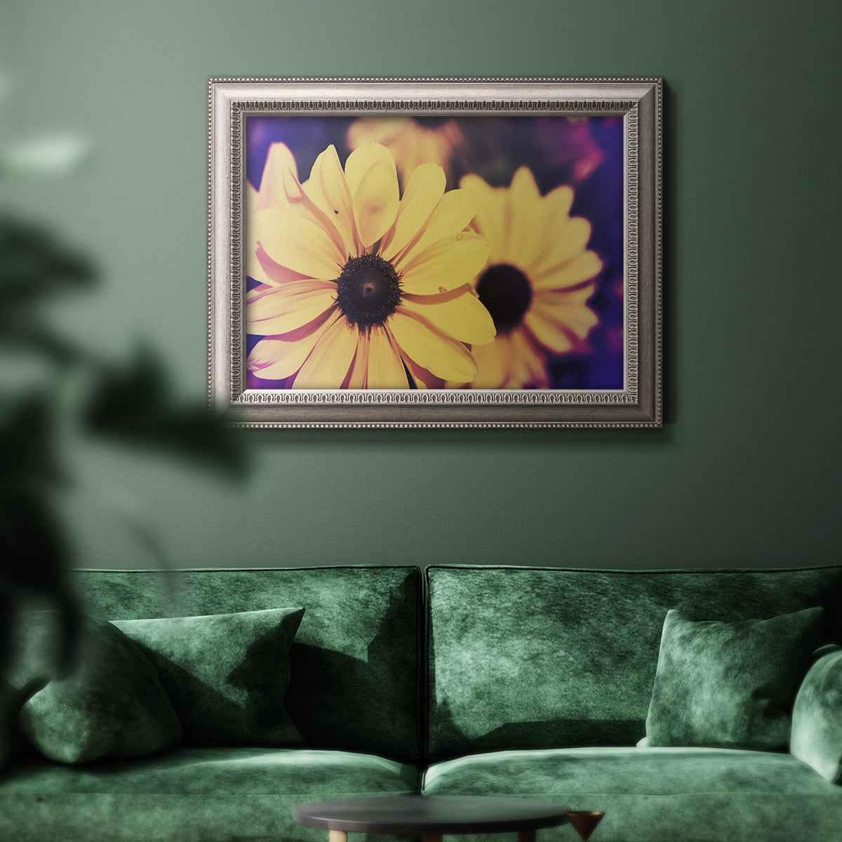 Bright black-eyed Susan flower photography in an ornate vintage silver frame displayed in a dark-toned interior setting.