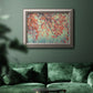 Eclectic fall floral landscape artwork in an ornate vintage silver frame displayed in a dark-toned interior setting.