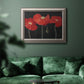 Modern red poppy floral artwork in an ornate vintage silver frame displayed in a dark-toned interior setting.