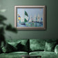 Coastal harbor watercolor painting in an ornate vintage silver frame displayed in a dark-toned interior setting.