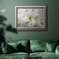 Close up view of peony petals in an ornate vintage silver frame displayed in a dark-toned interior setting.