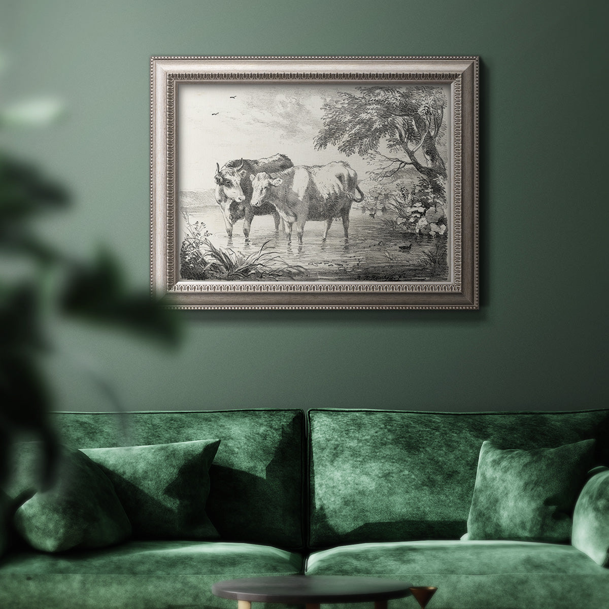 Classical countryside landscape artwork by Nicolas Berchem in an ornate vintage silver frame displayed in a dark-toned interior setting.