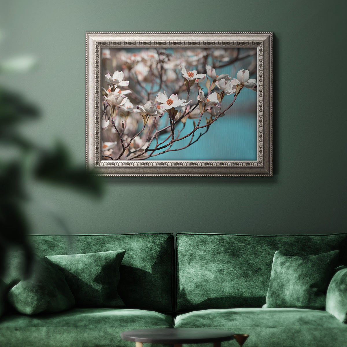 Color-rich dogwood floral photography in an ornate vintage silver frame displayed in a dark-toned interior setting.