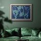 Blue abstract botanical in an ornate vintage silver frame displayed in a dark-toned interior setting.