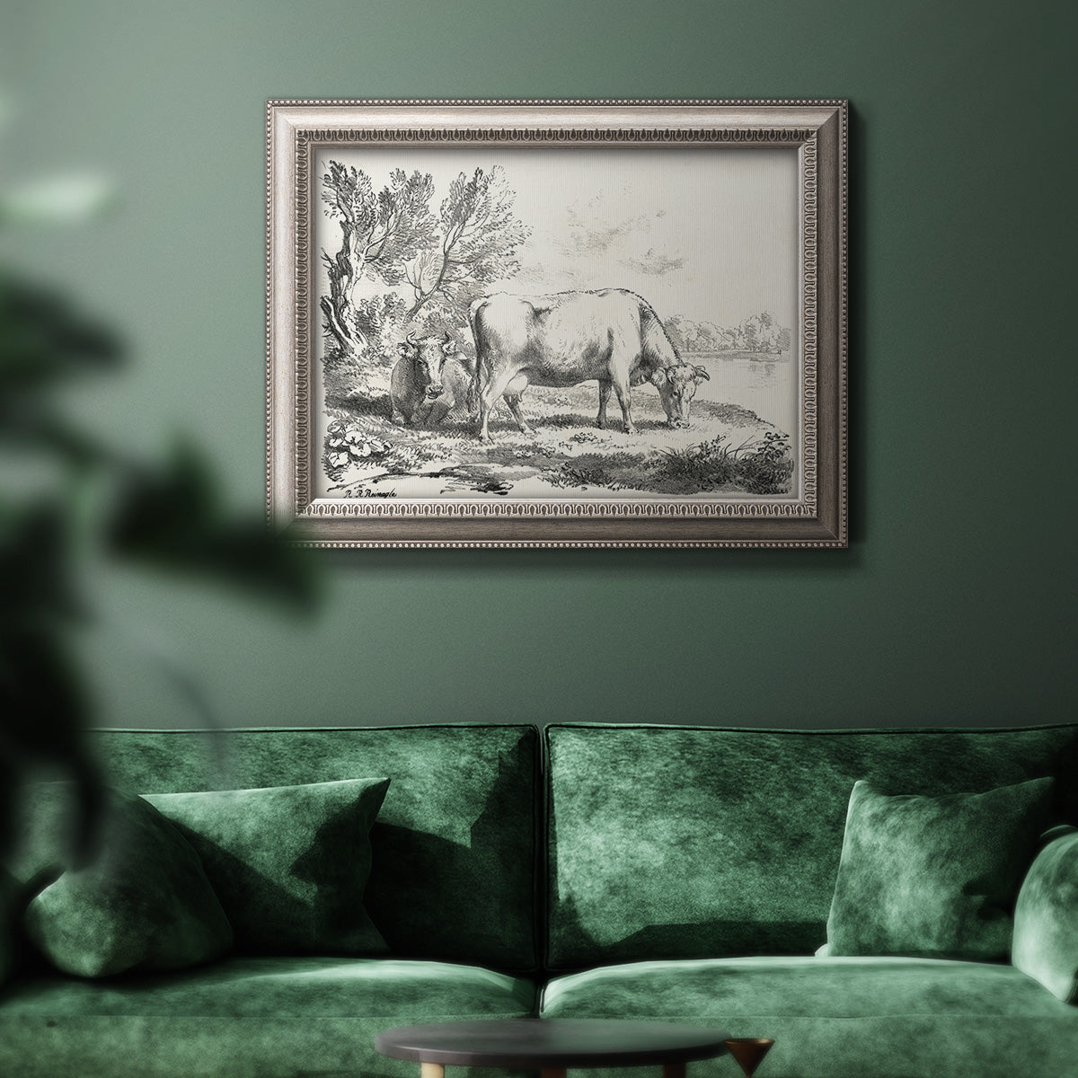 Traditional rural landscape scene by Nicolas Berchem in an ornate vintage silver frame displayed in a dark-toned interior setting.