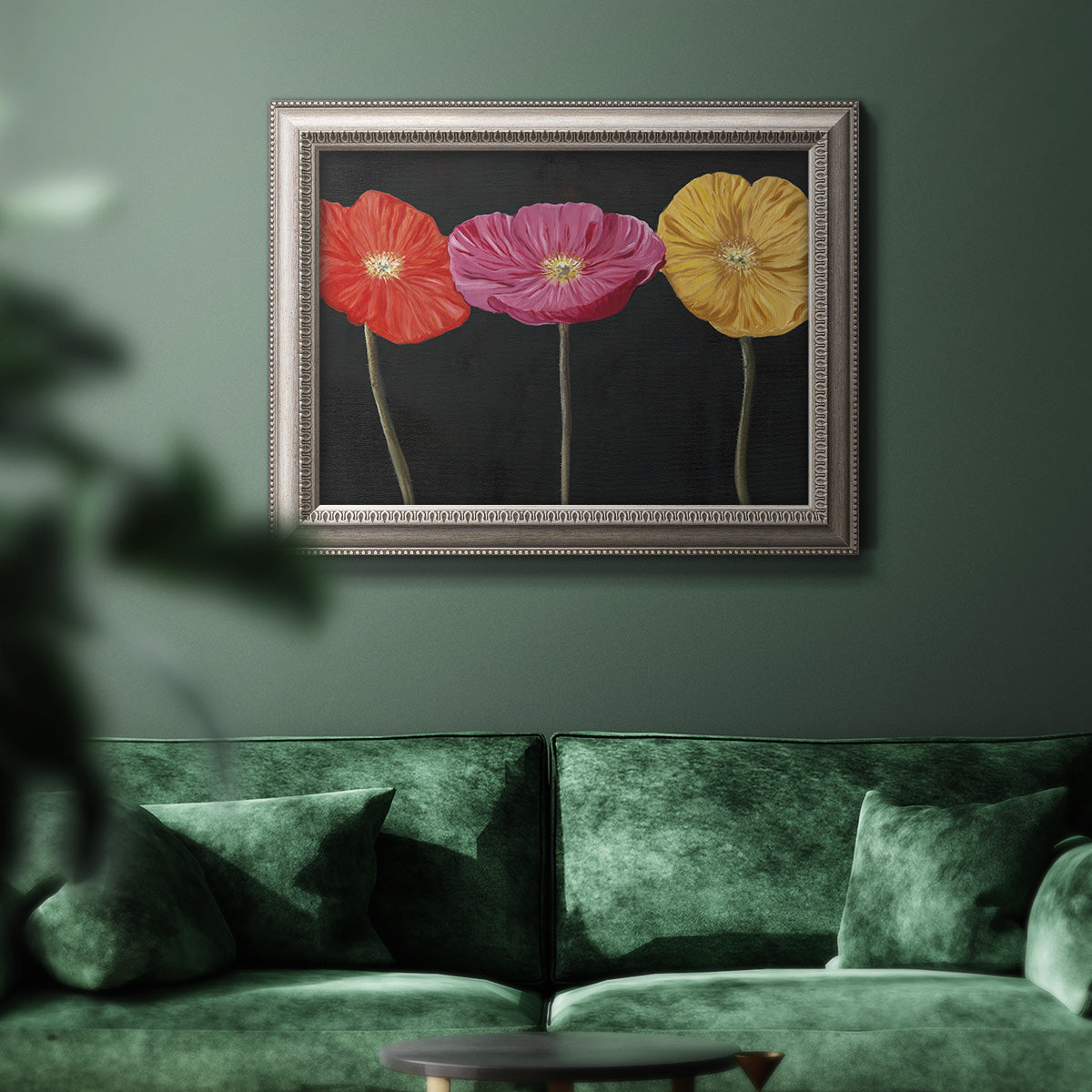 Contemporary poppy flower artwork in an ornate vintage silver frame displayed in a dark-toned interior setting.