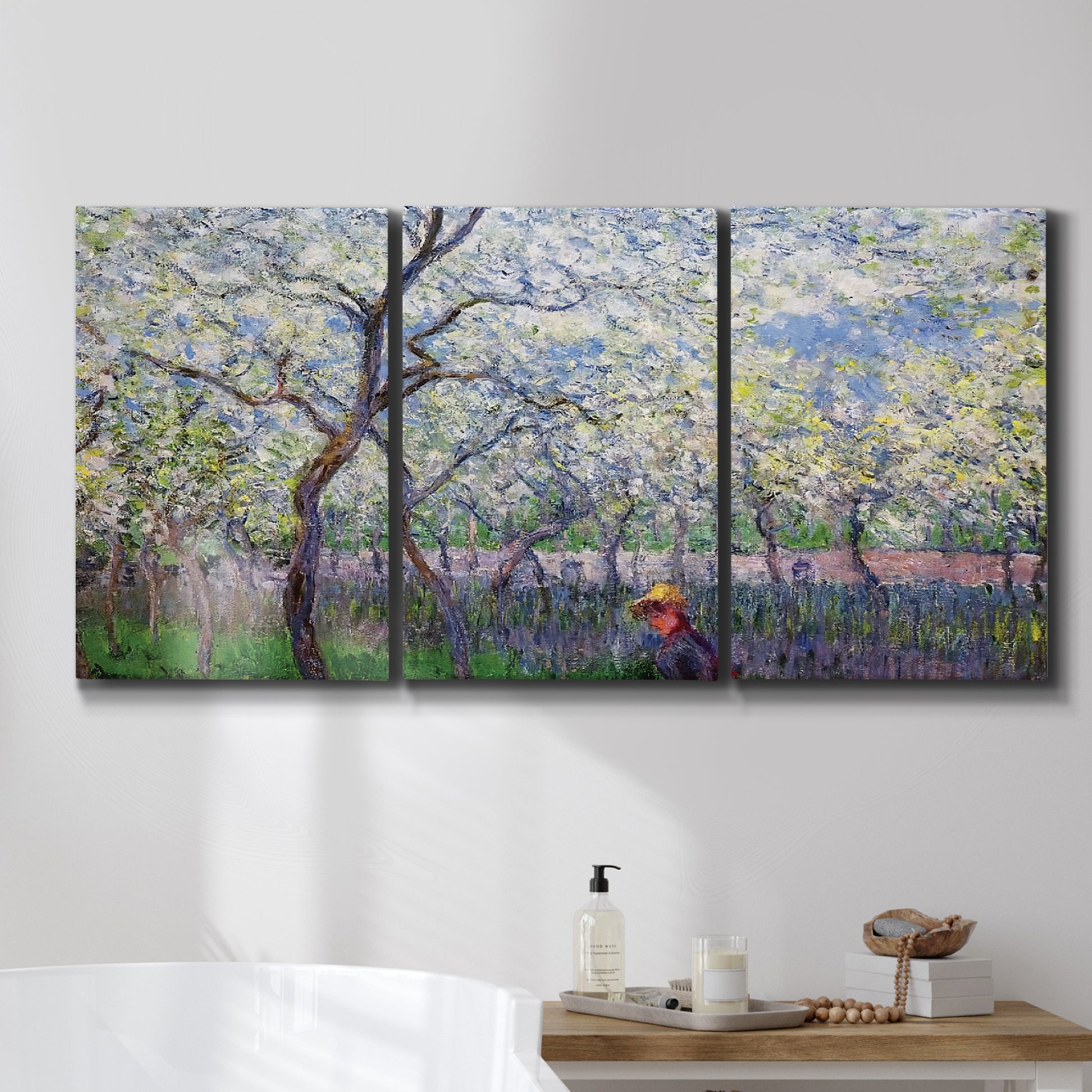 Three-panel canvas wall art featuring fresh spring countryside landscape, displayed in a bathroom above a bathtub.