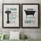 Set of two black barnwood framed canvas prints depicting a coordinated art pair of playful bathtub silhouettes and bath-themed typography rendered as graphic bathroom word art above a sofa in a modern living room.