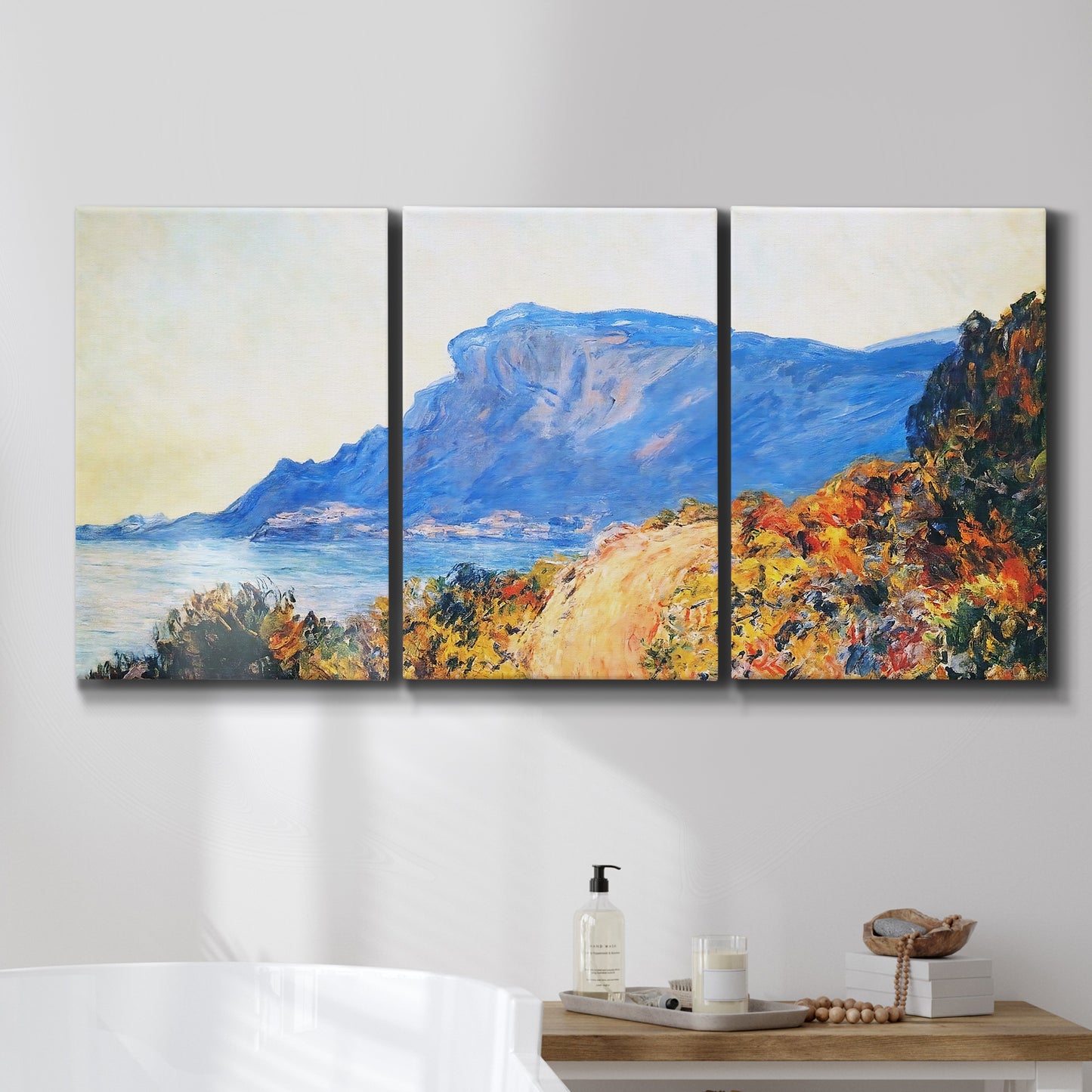Three-panel canvas wall art featuring winding red road hillside, displayed in a bathroom above a bathtub.