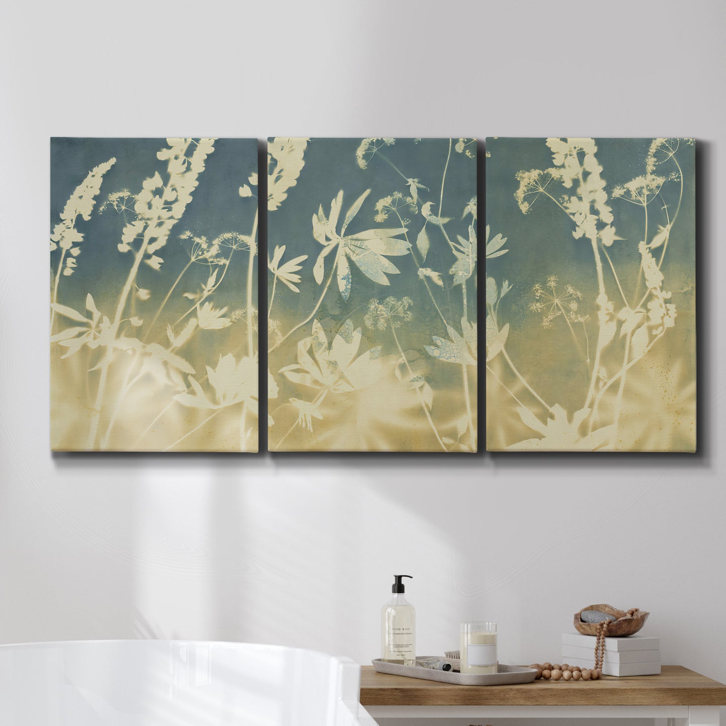 Three-panel canvas wall art featuring lupine flowers in seasonal bloom, displayed in a bathroom above a bathtub.