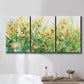 Three-panel canvas wall art featuring colorful garden flowers in bloom, displayed in a bathroom above a bathtub.