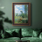 Impressionist pastoral landscape with poppy fields by Claude Monet in an ornate bronzed mahogany wood frame displayed in a dark-toned interior setting.