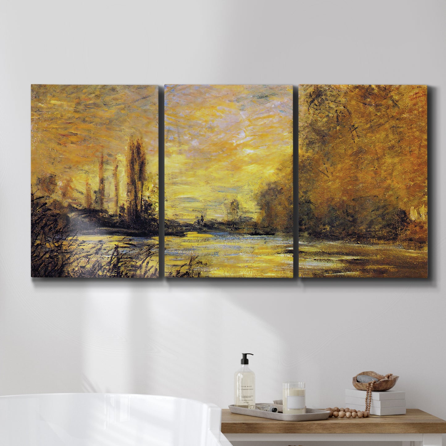 Three-panel canvas wall art featuring quiet river branch landscape, displayed in a bathroom above a bathtub.