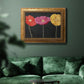 Contemporary poppy flower artwork in an ornate vintage gold frame displayed in a dark-toned interior setting.