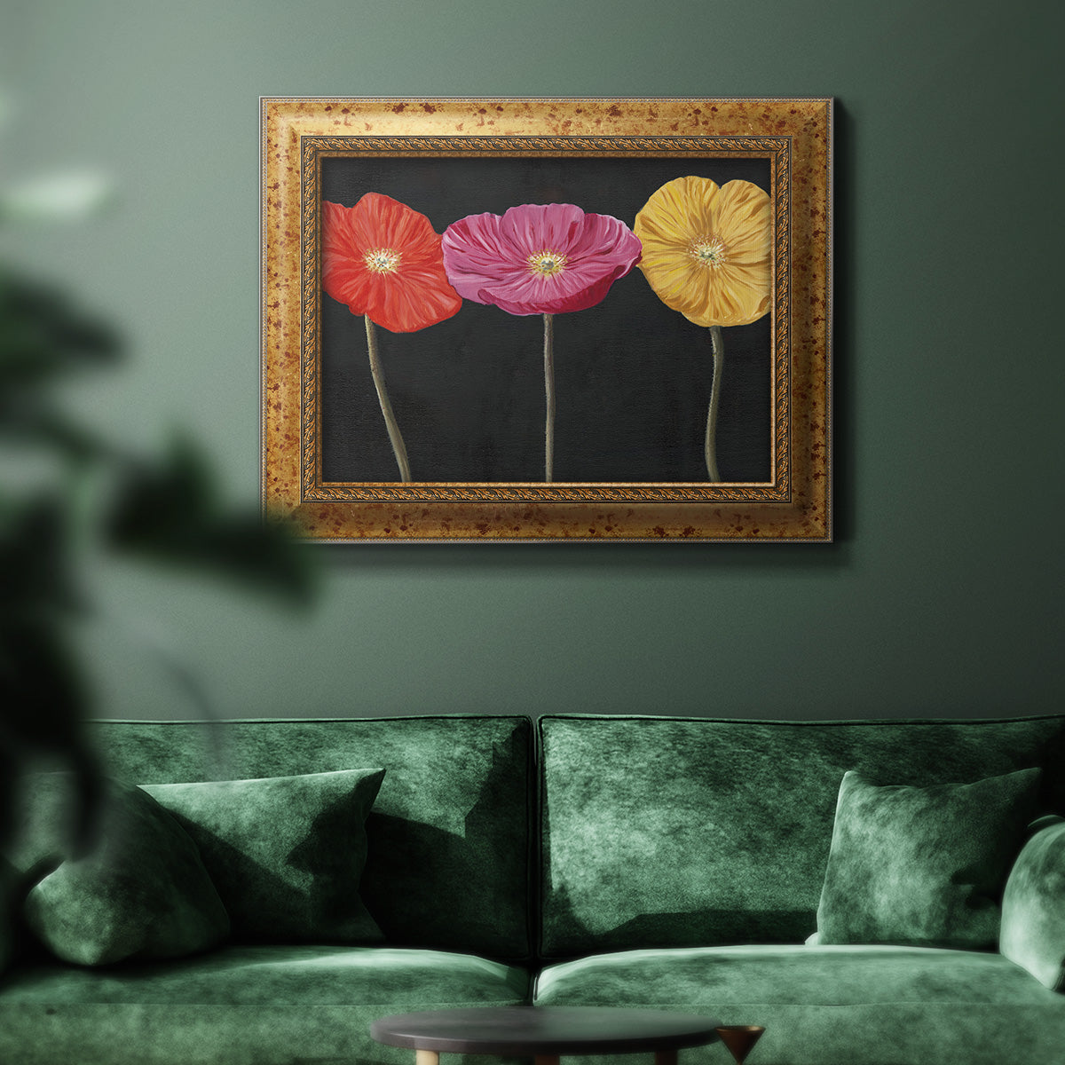 Contemporary poppy flower artwork in an ornate vintage gold frame displayed in a dark-toned interior setting.