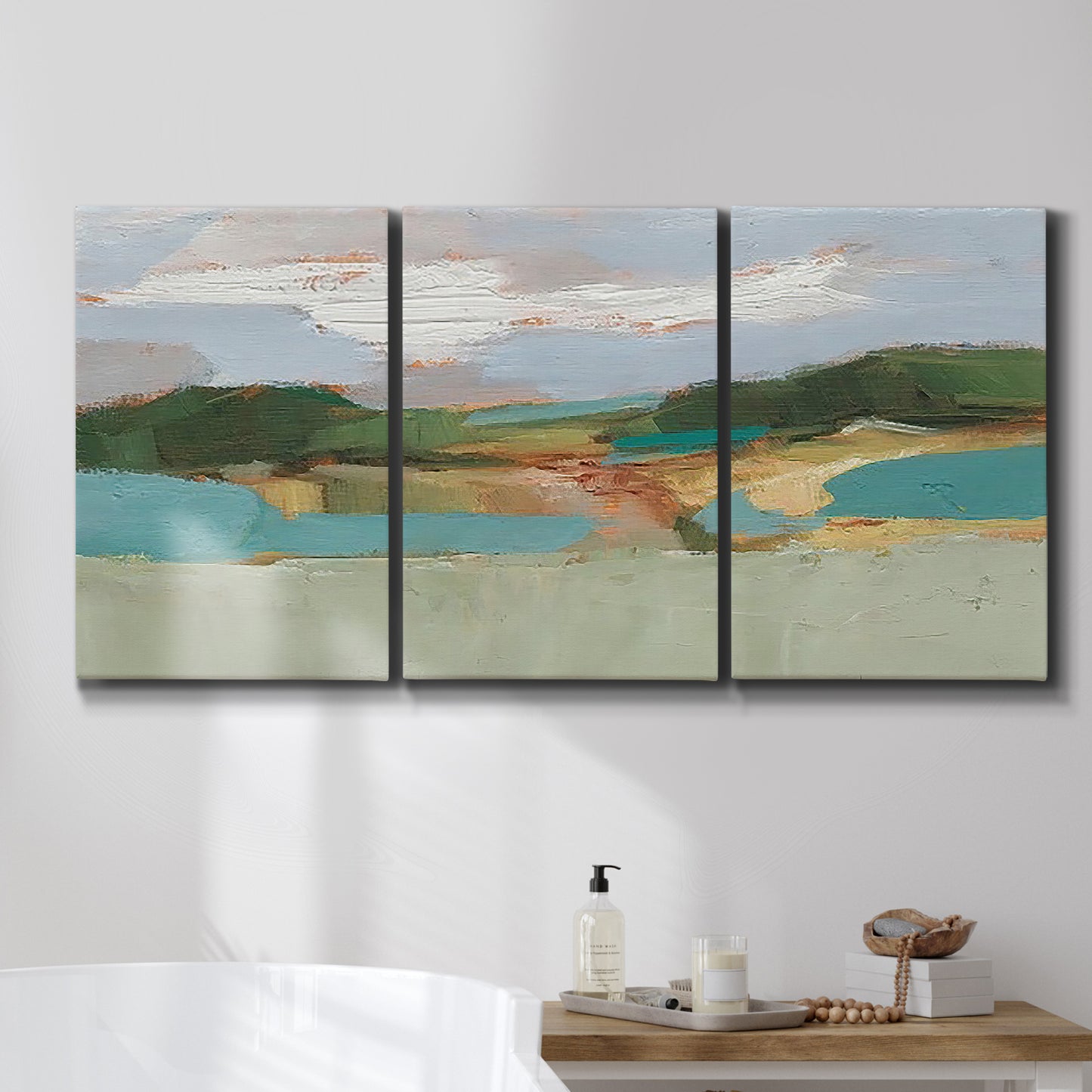 Three-panel canvas wall art featuring wide open landscape under midday light, displayed in a bathroom above a bathtub.