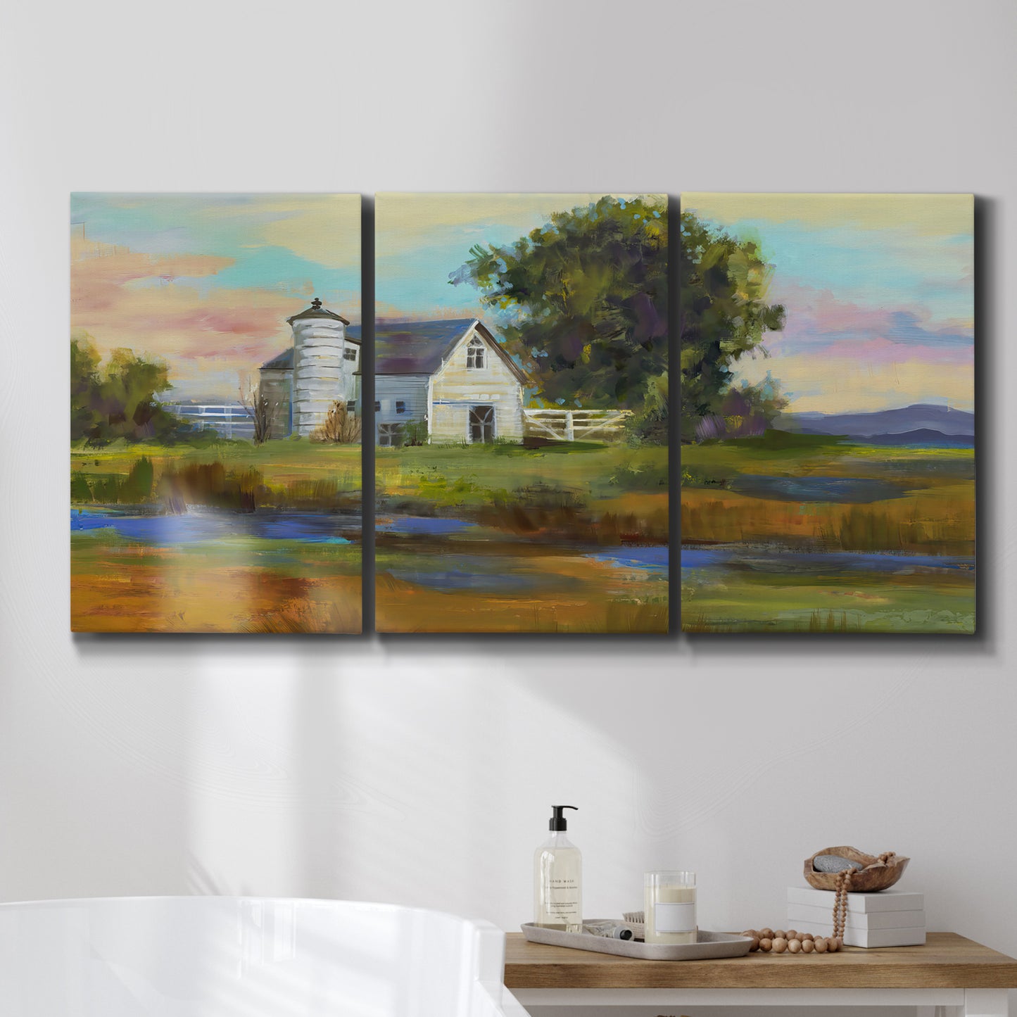 Three-panel canvas wall art featuring rural barn landscape with fields, displayed in a bathroom above a bathtub.