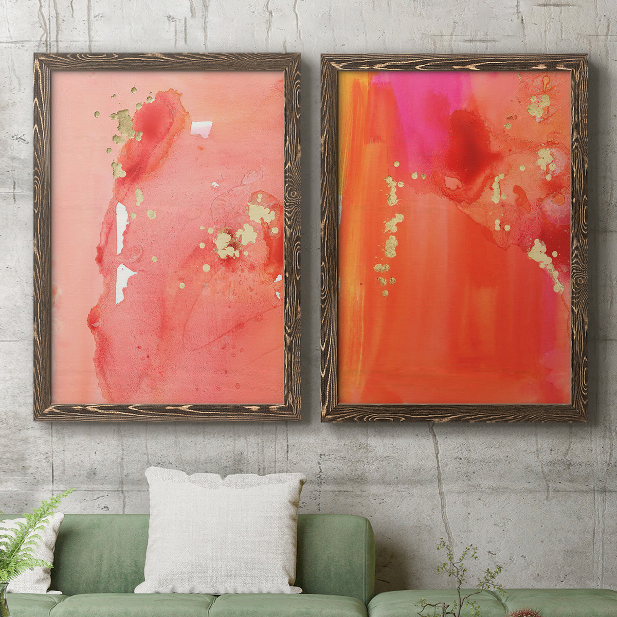 Set of two walnut barnwood framed canvas prints depicting a coordinated art pair of luminous coral orange and pink color fields with gold flecks rendered as glamorous fluid abstracts above a sofa in a modern living room.