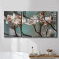 Three-panel canvas wall art featuring dogwood blossoms in spring photograph, displayed in a bathroom above a bathtub.