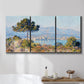 Three-panel canvas wall art featuring coastal town viewed from hillside, displayed in a bathroom above a bathtub.