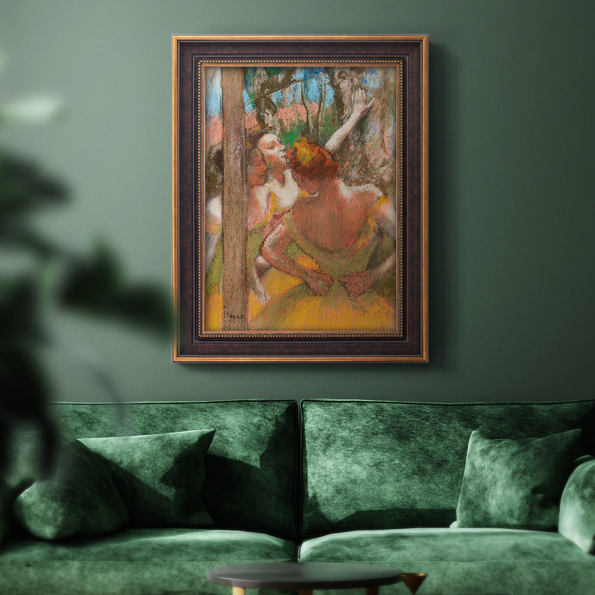 Impressionist ballet dancer composition by Edgar Degas in an ornate bronzed mahogany wood frame displayed in a dark-toned interior setting.
