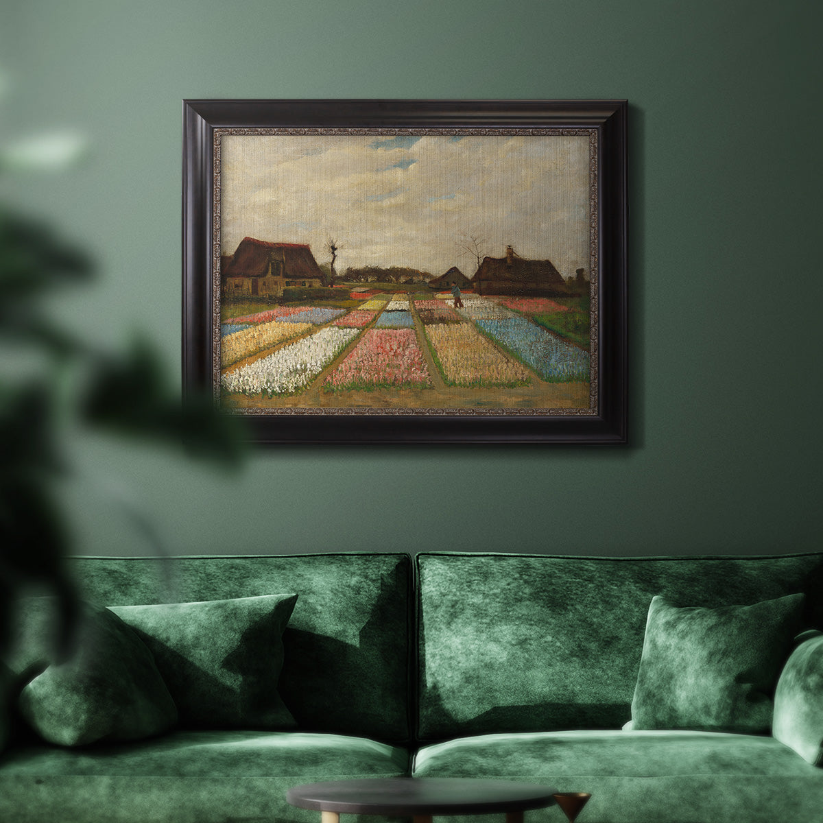 Impressionist Dutch bulb field landscape by Vincent van Gogh in an ornate black frame with gilded inner detail displayed in a dark-toned interior setting.