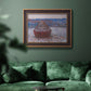 Impressionist single haystack landscape by Claude Monet in an ornate bronzed mahogany wood frame displayed in a dark-toned interior setting.