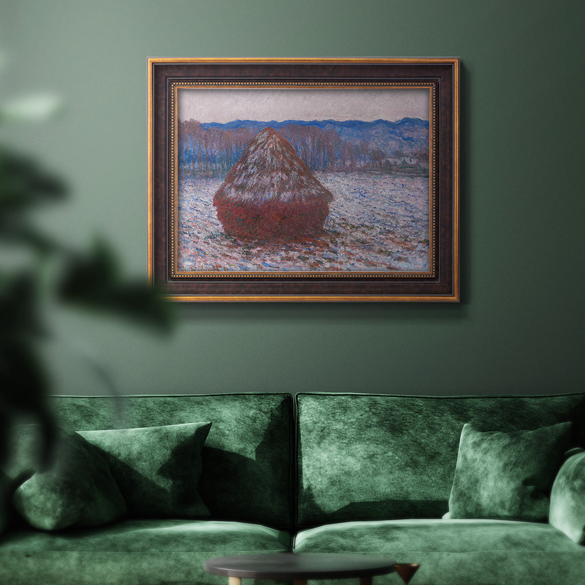 Impressionist single haystack landscape by Claude Monet in an ornate bronzed mahogany wood frame displayed in a dark-toned interior setting.