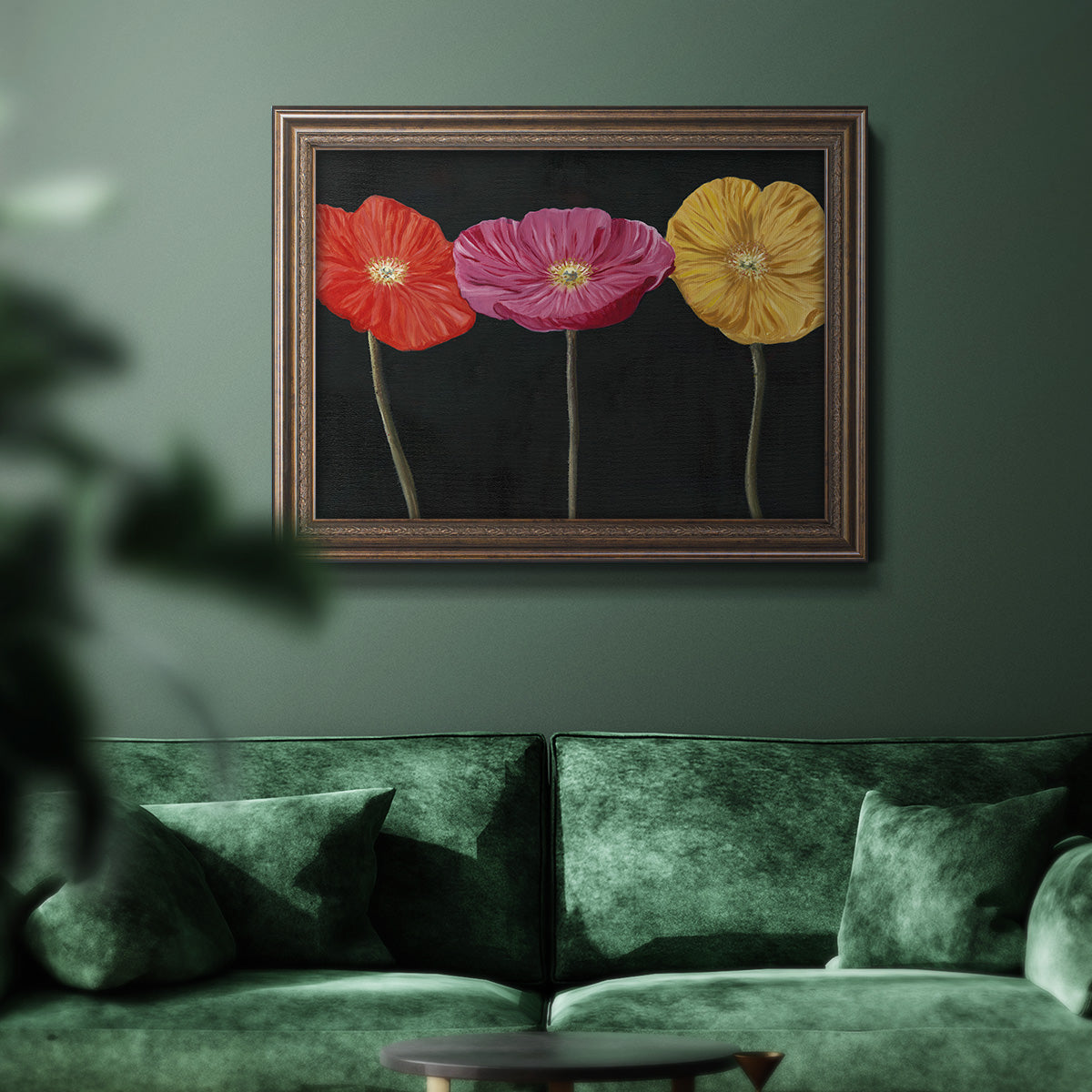 Contemporary poppy flower artwork in an ornate traditional bronze frame displayed in a dark-toned interior setting.