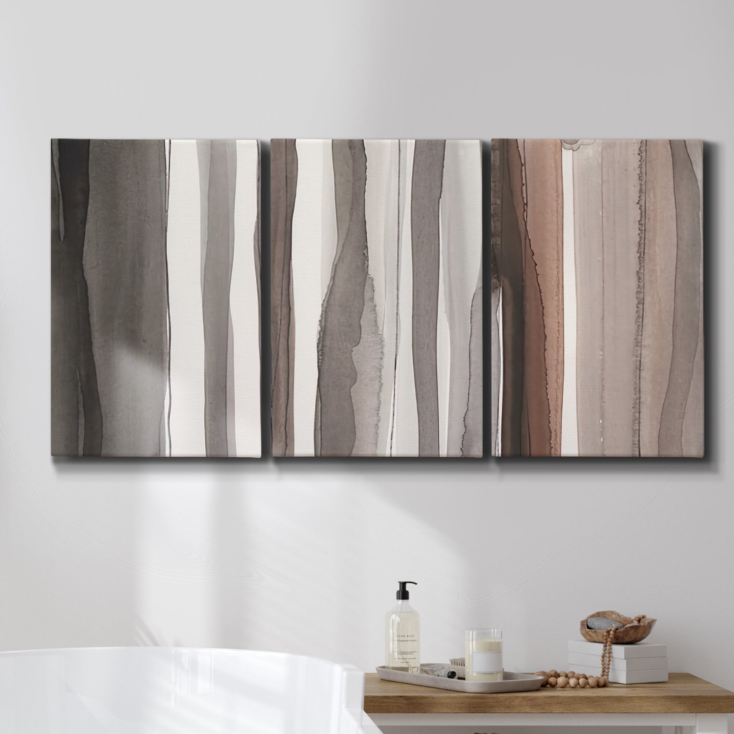 Three-panel canvas wall art featuring riverbank landscape with reflections, displayed in a bathroom above a bathtub.
