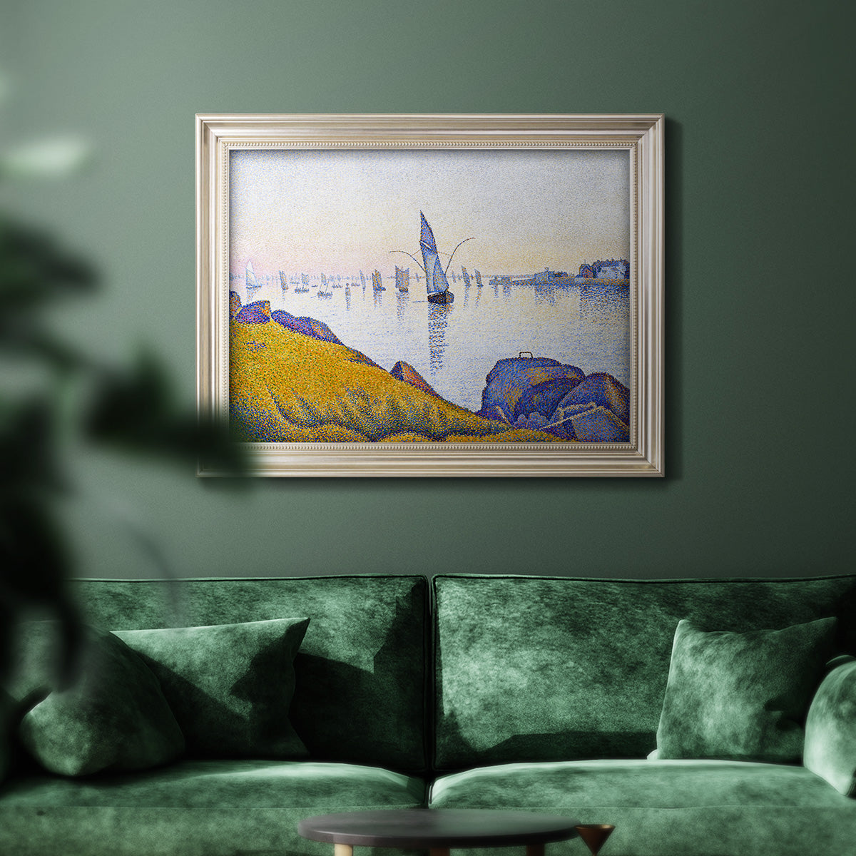 Impressionist coastal harbor at dusk by Paul Signac in an ornate champagne frame displayed in a dark-toned interior setting.