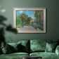Impressionist residential landscape at Argenteuil by Claude Monet in an ornate champagne frame displayed in a dark-toned interior setting.