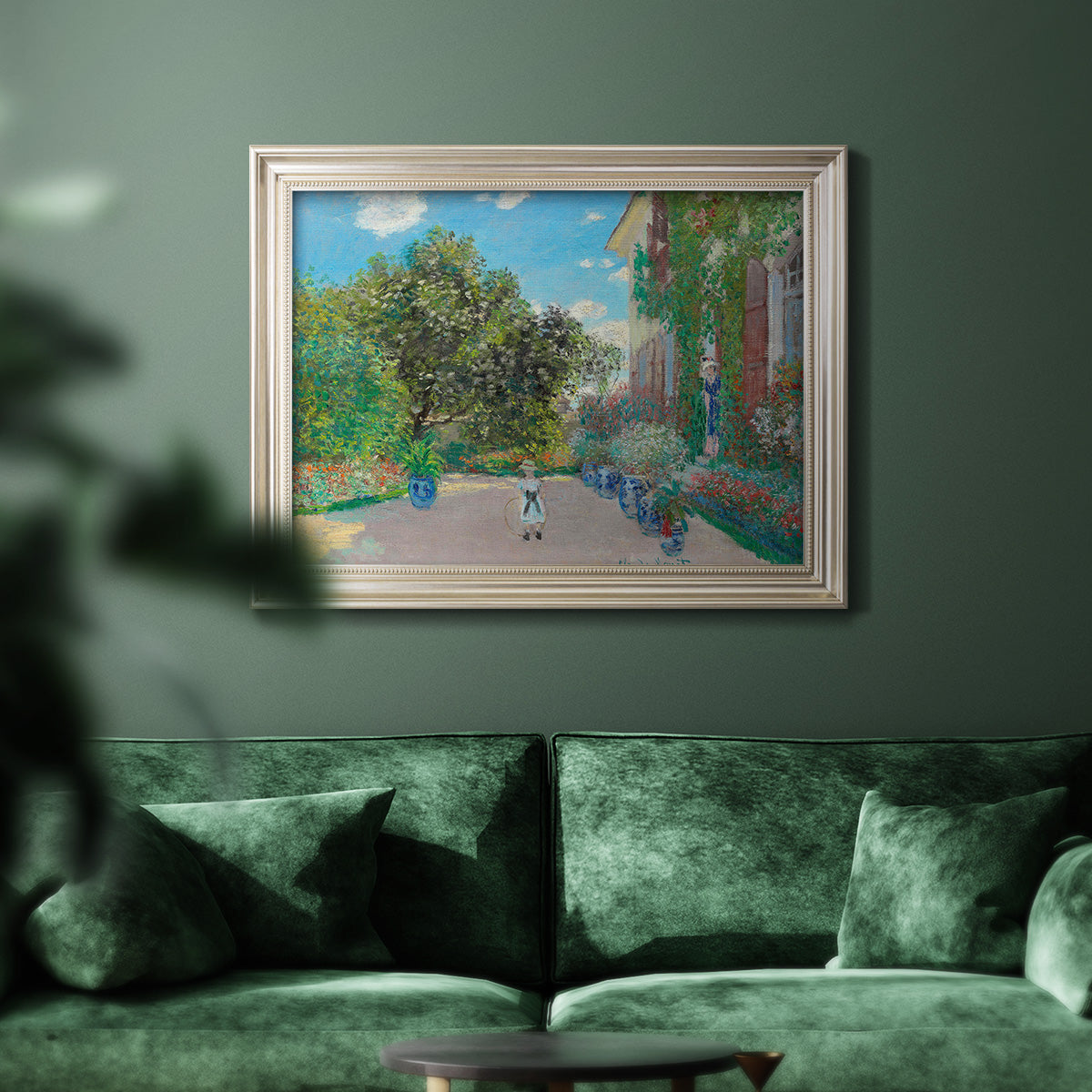 Impressionist residential landscape at Argenteuil by Claude Monet in an ornate champagne frame displayed in a dark-toned interior setting.