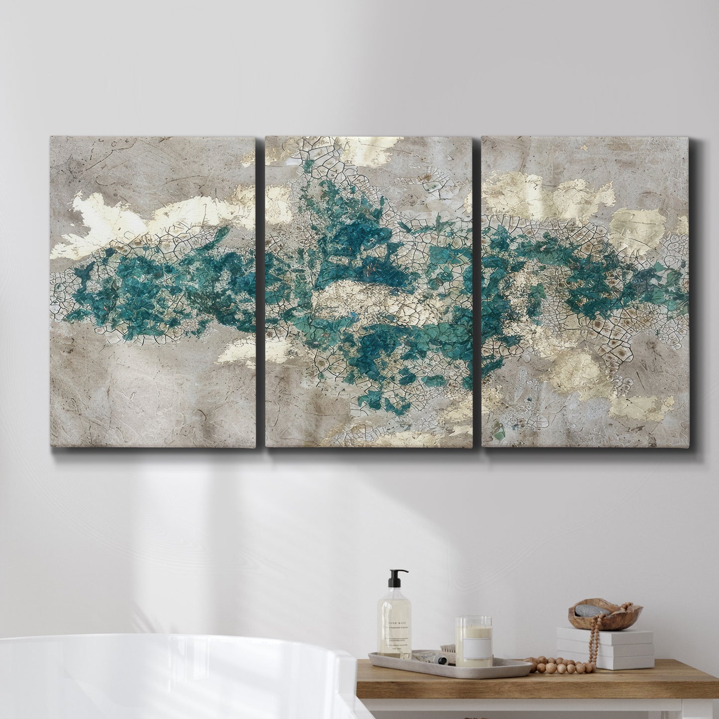 Three-panel canvas wall art featuring layered mineral abstract textures, displayed in a bathroom above a bathtub.