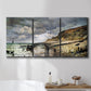 Three-panel canvas wall art featuring sunset beach with glowing sky, displayed in a bathroom above a bathtub.