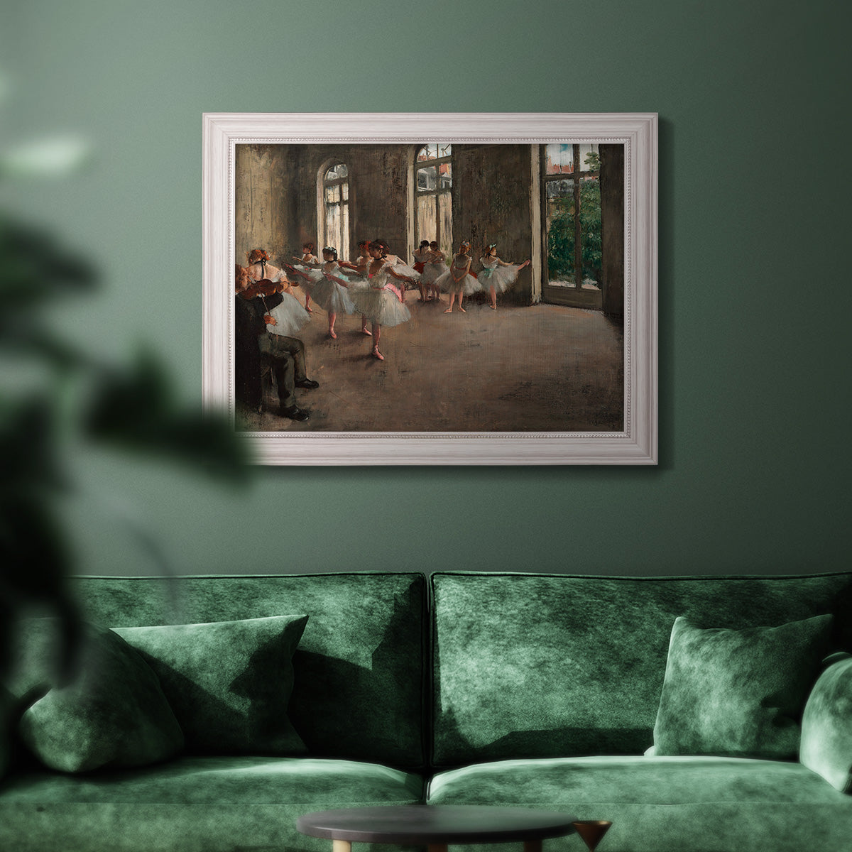 Early impressionist ballet rehearsal painting by Edgar Degas in an ornate weathered white frame displayed in a dark-toned interior setting.