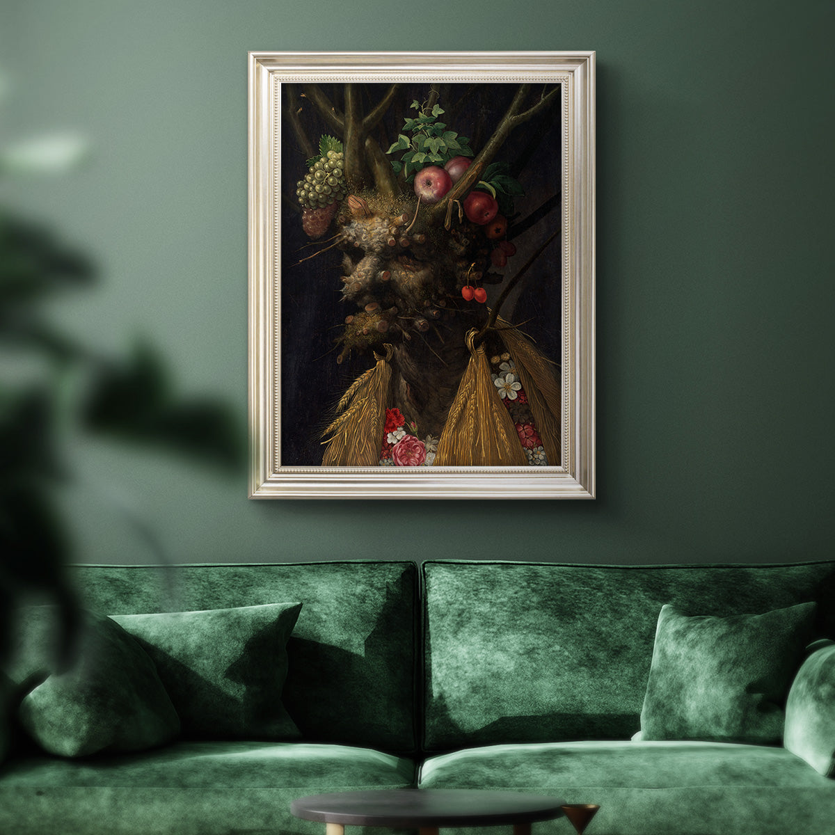 Surreal allegorical portrait representing the four seasons by Giuseppe Arcimboldo in an ornate champagne frame displayed in a dark-toned interior setting.