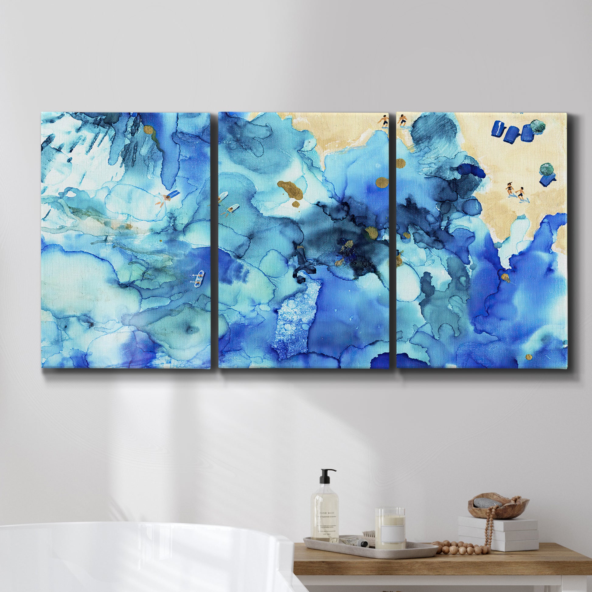 Three-panel canvas wall art featuring abstract coastal beach color fields, displayed in a bathroom above a bathtub.