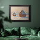 Impressionist winter haystack scene by Claude Monet in an ornate black frame with gilded inner detail displayed in a dark-toned interior setting.
