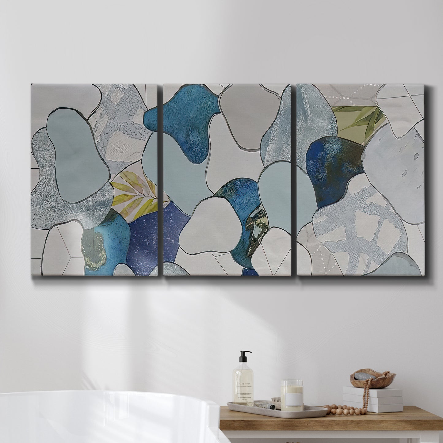 Three-panel canvas wall art featuring mid century geometric pink abstraction, displayed in a bathroom above a bathtub.