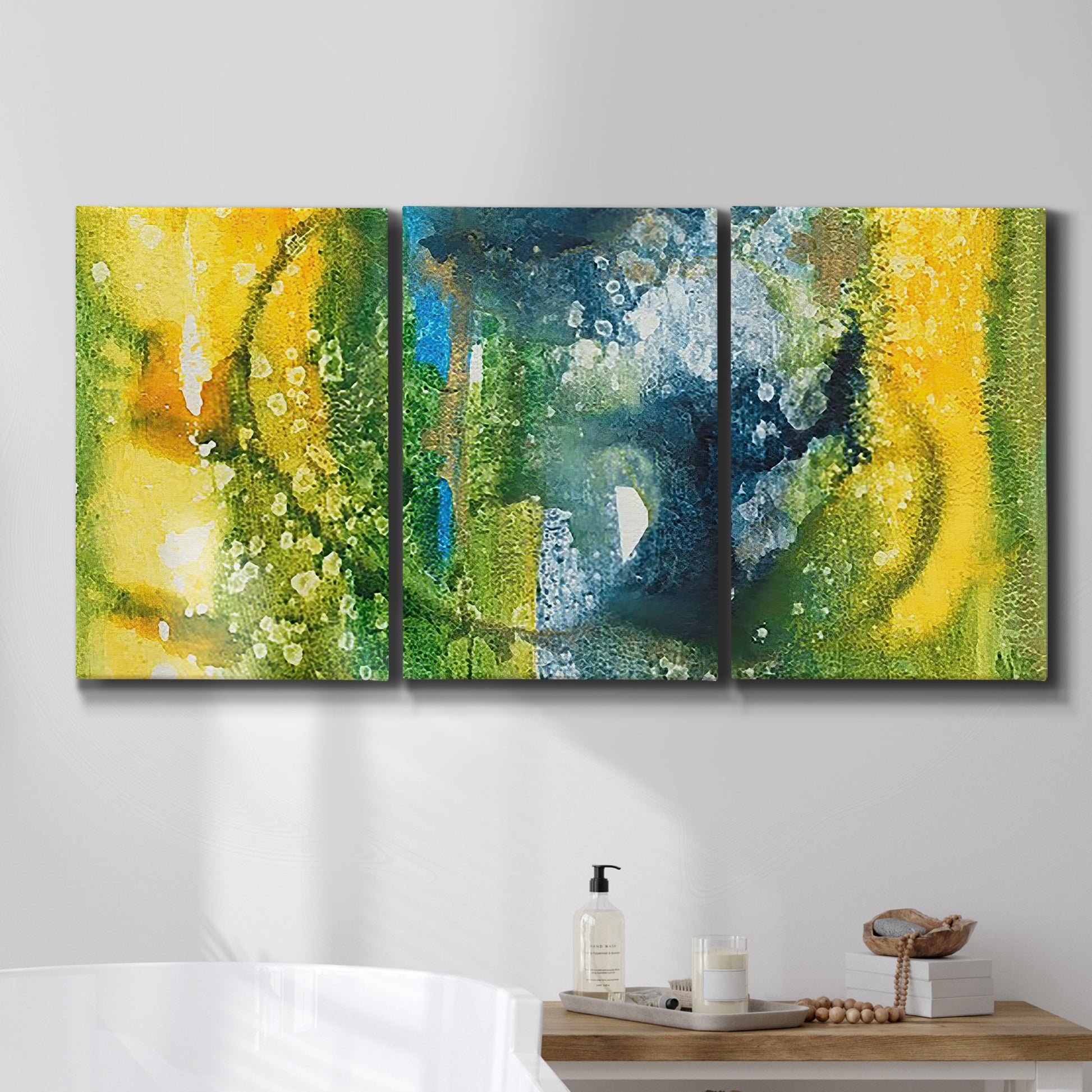Three-panel canvas wall art featuring energetic abstract aquatic color motion, displayed in a bathroom above a bathtub.