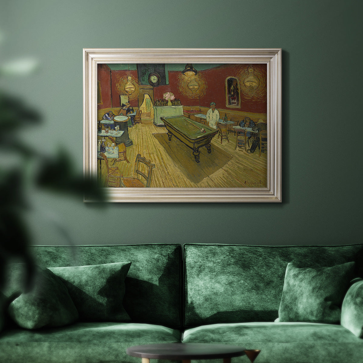 Impressionist interior of a night café by Vincent van Gogh in an ornate champagne frame displayed in a dark-toned interior setting.