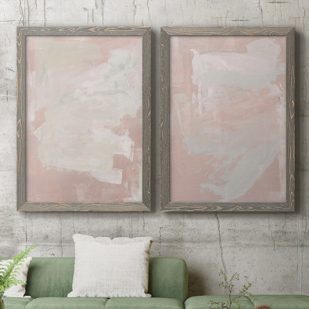 Set of two gray barnwood framed canvas prints depicting a coordinated art pair of soft blush and white painterly fields rendered as minimalist color-field abstracts above a sofa in a modern living room.
